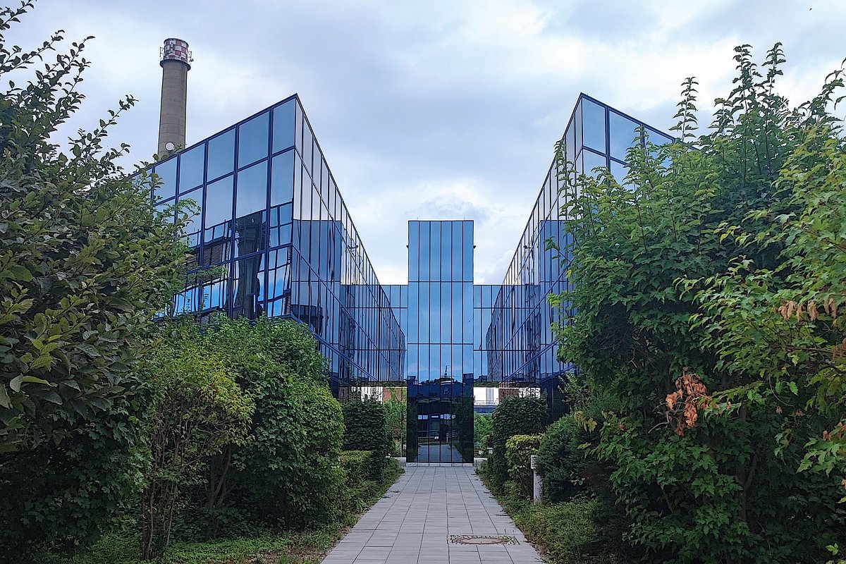 Ein blaues Gebäude bestehend aus vielen Glasfronten. Es handelt sich um das Innovationsforum in Hennigsdorf.